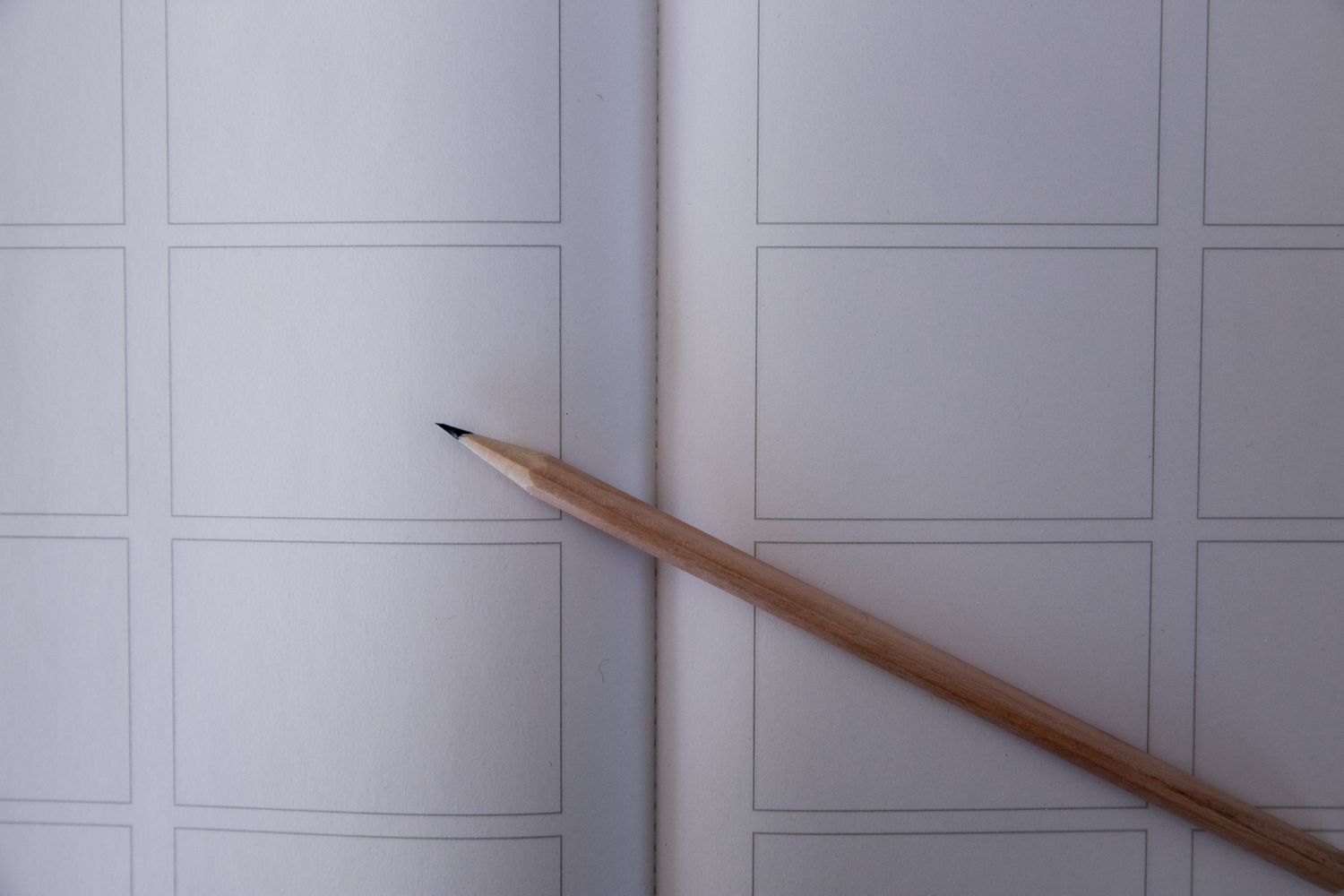 A pencil on a template with frames for a storyboard.