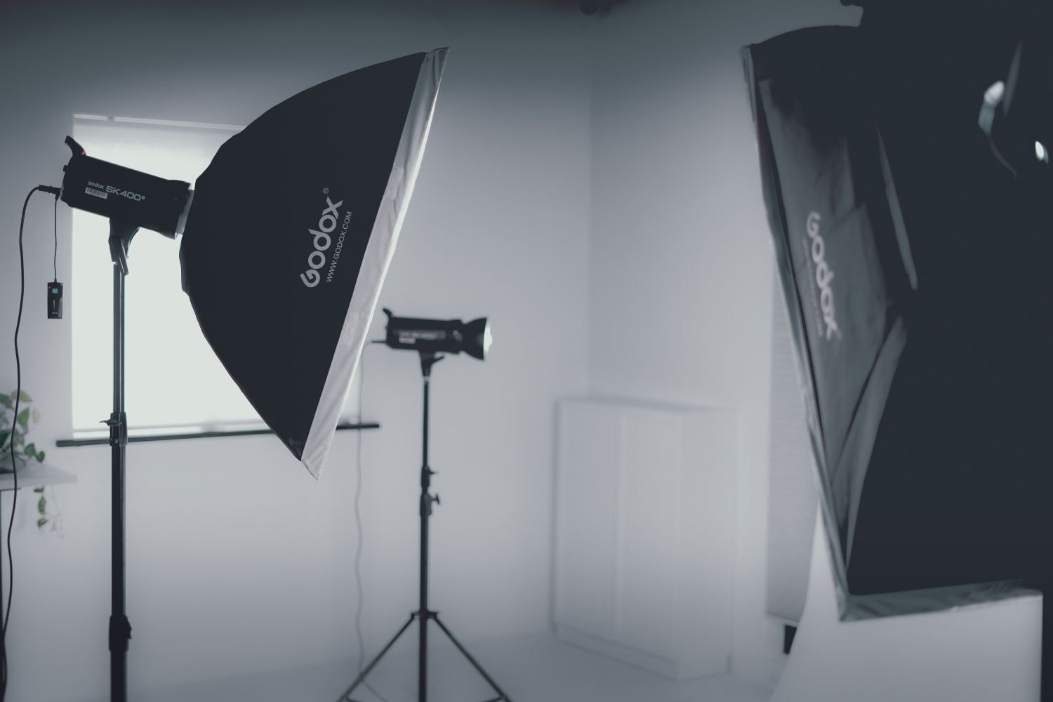 Lights and stands inside a compact white studio.