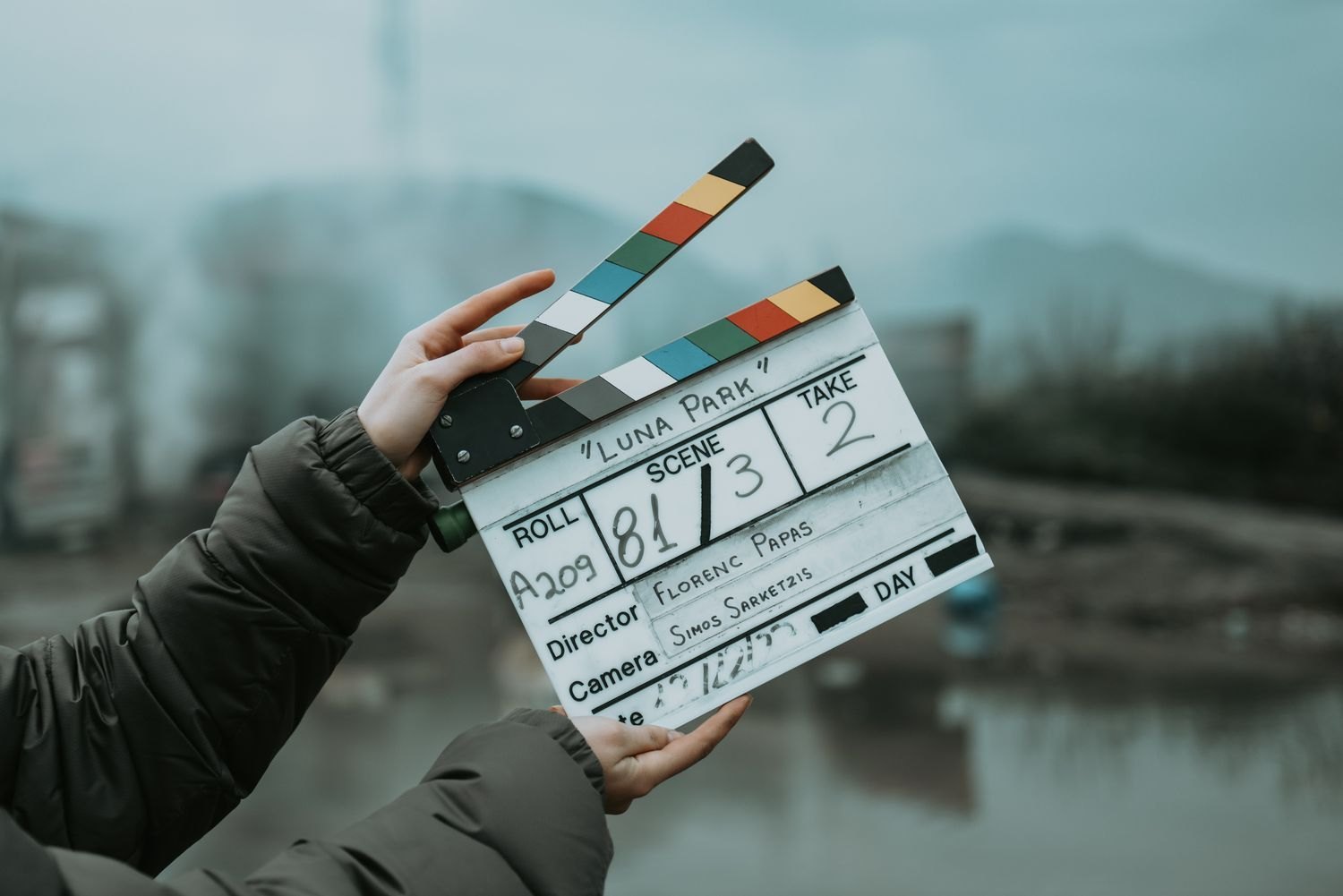 A clapperboard held before an outdoor take.